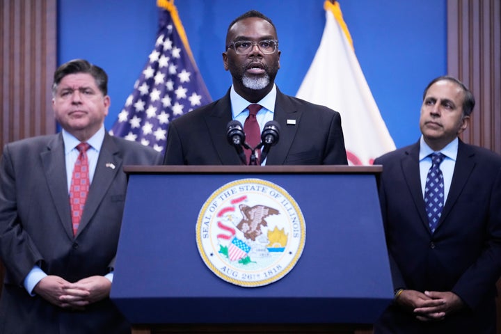 Chicago Mayor Brandon Johnson, center, speaks as Governor JB Pritzker, left, and US Representative Raja Krishnamoorthi listen to him at a news conference in Chicago, Monday, Oct. 6, 2025.