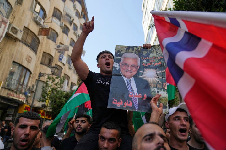 Palestinians at a rally supporting Gaza carry posters of President Mahmoud Abbas while celebrating the latest Western nations recognizing a Palestinian state, in the West Bank city of Ramallah, on Sept. 23, 2025.