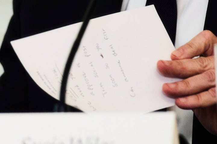 Secretary of State Marco Rubio writes a note before handing it to President Donald Trump during a roundtable meeting on antifa in the State Dining Room at the White House, Wednesday, Oct. 8, 2025, in Washington. (AP Photo/Evan Vucci)