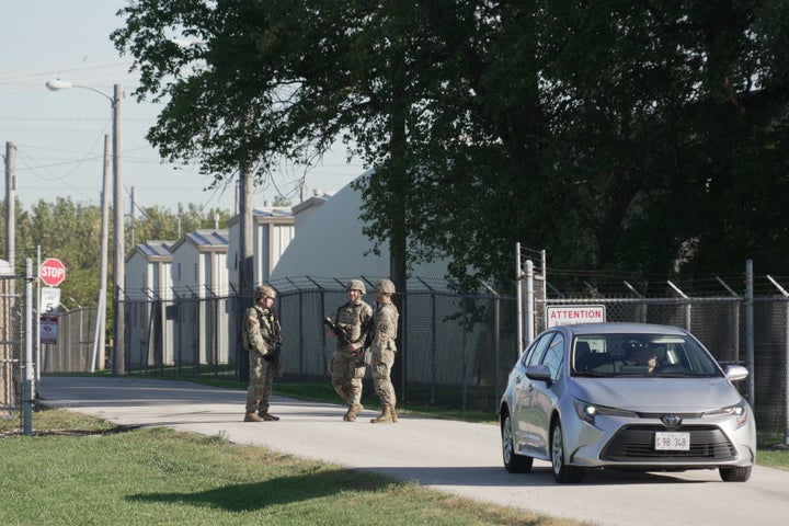 Military personnel in uniform, with the Texas National Guard patch on, are seen at the U.S. Army Reserve Center, Wednesday, Oct. 8, 2025, in Elwood, Ill., a suburb of Chicago. (AP Photo/Laura Bargfeld)