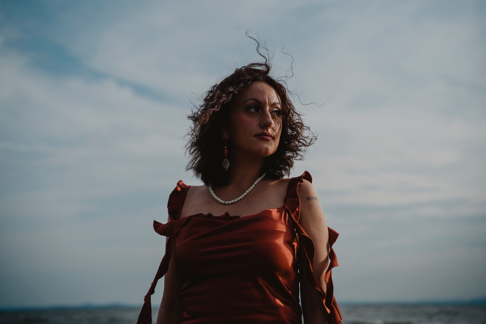 Molly Dickin, of Burlington, Vermont, poses last month at a family home on Lake Champlain in neighboring Colchester. When she was 17, Dickin began an 11-month stay at Spring Ridge Academy, a now-closed center in Arizona that some former students say was abusive. 