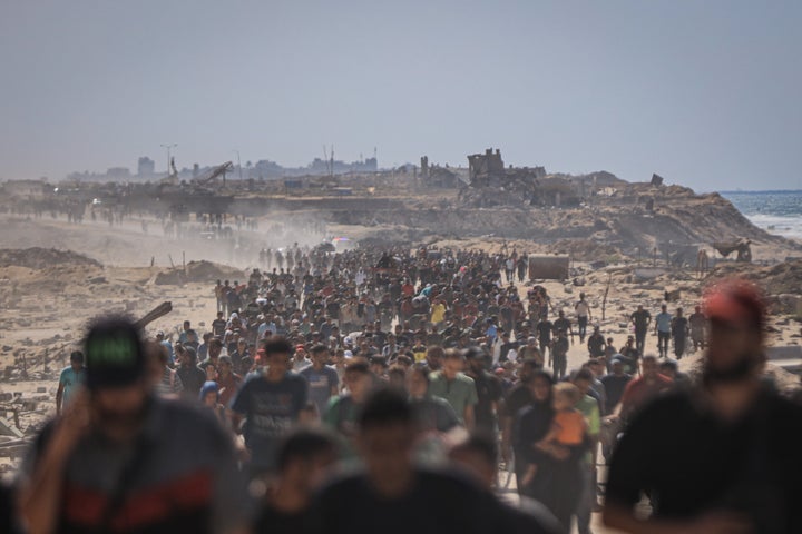 Israeli Navy Says Ceasefire Takes Impact In Gaza, Elevating Hopes For Ending The Battle 1 Palestinians walk along al-Rashid Street, the main coastal road connecting southern and central Gaza to the north, as they return to their homes following the new ceasefire agreement between Israel and Hamas in Gaza City, Gaza, on Oct. 10, 2025.