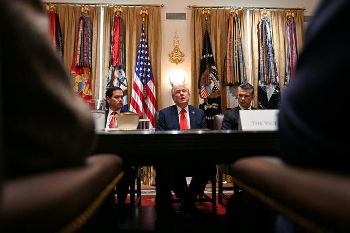 Trump (center) speaks, alongside Secretary of State Marco Rubio (left) and Secretary of Defense Pete Hegseth (right), during a Cabinet meeting in the Cabinet Room of the White House in Washington, DC, on October 9.
