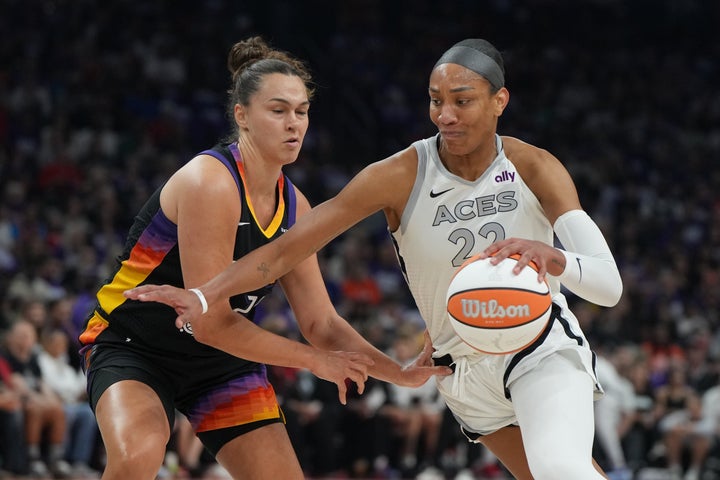 Las Vegas Aces center A'ja Wilson (22) drives on Phoenix Mercury forward Kathryn Westbeld (24) during the first half of Game 4 of the WNBA basketball finals, Friday, Oct. 10, 2025, in Phoenix. (AP Photo/Rick Scuteri)