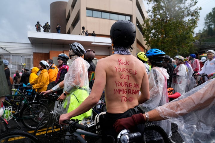 Demonstrators stand in protest against Donald Trump's immigration policies at the U.S. Immigration and Customs Enforcement facility after the Naked Bike ride protest on Sunday in Portland, Oregon.