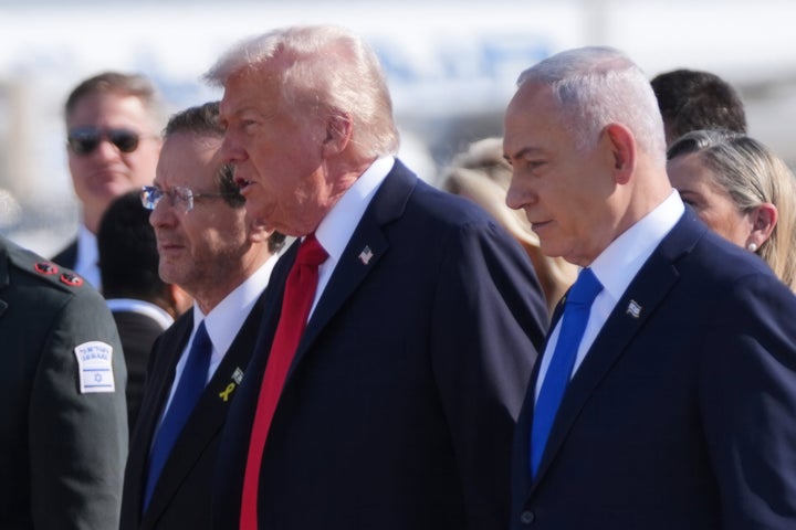 President Donald Trump walks with Israel's President Isaac Herzog, left, and Israel's Prime Minister Benjamin Netanyahu during an arrival ceremony at Ben Gurion International Airport, on Oct. 13, 2025, near Tel Aviv.