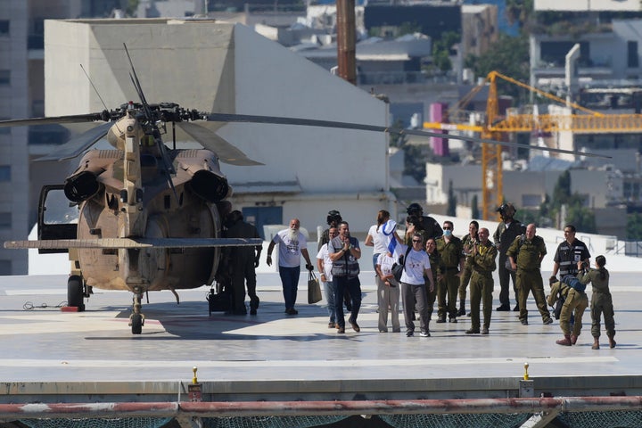 Omri Miran, an Israeli hostage released from the Gaza Strip waves an Israeli flag after coming off a helicopter at the Ichilov Hospital, in Tel Aviv, Israel, on Oct. 13, 2025.