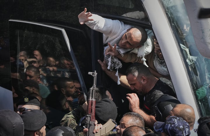 Palestinian prisoners wave to the crowd after being released from Israeli prison following a ceasefire agreement between Israel and Hamas, on Oct. 13, 2025.