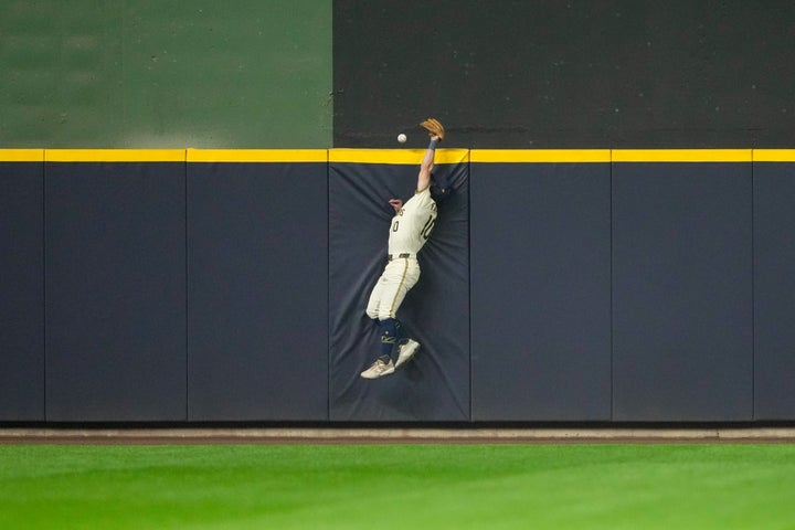 Sal Frelick, #10 of the Milwaukee Brewers, makes a leaping attempt at a catch in the fourth inning during Game 1 of the NLCS on Monday. (Photo by Aaron Gash/MLB Photos via Getty Images)
