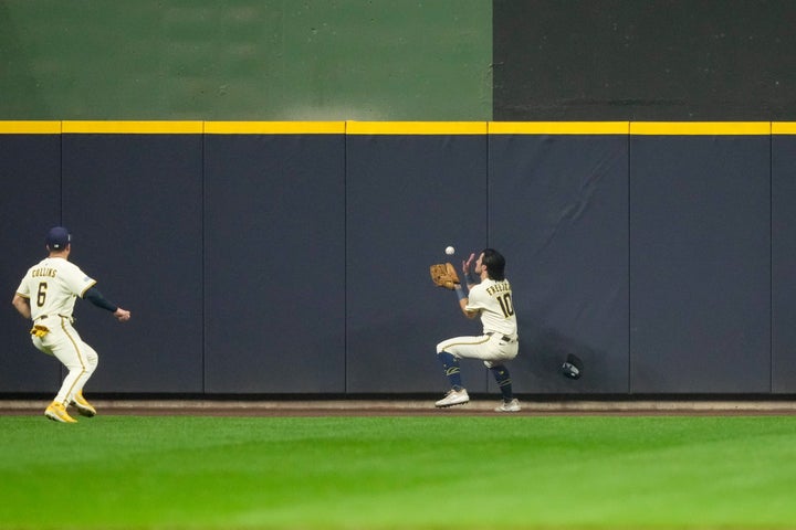 Sal Frelick, #10 of the Milwaukee Brewers, catches the ball off the outfield wall in the fourth inning during Game 1 of the NLCS on Monday. (Photo by Aaron Gash/MLB Photos via Getty Images)