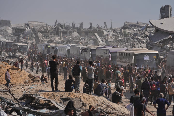Buses carrying freed Palestinian prisoners drive past destroyed buildings in the Gaza Strip after their release from Israeli jails under a ceasefire agreement between Hamas and Israel, in Khan Younis, southern Gaza Strip, on Oct. 13, 2025.
