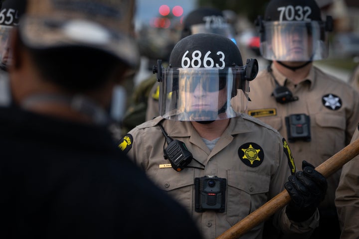 Police photographed in front of protesters outside of the immigration processing and detention facility on October 11, 2025 in Broadview, Illinois.