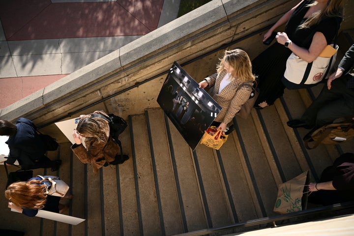 Reporters carry their belongings from the Pentagon in Washington, D.C., on Oct. 15, 2025, after many news outlets declined to sign new restrictive Pentagon media rules and were stripped of their press credentials. The new rules come after the Defense Department restricted media access inside the Pentagon, forced some outlets to vacate offices in the building and drastically reduced the number of briefings for journalists.