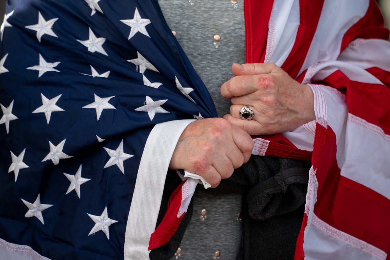 A demonstrator wrapped in an American flag during a "No Kings" protest in Washington, D.C.
