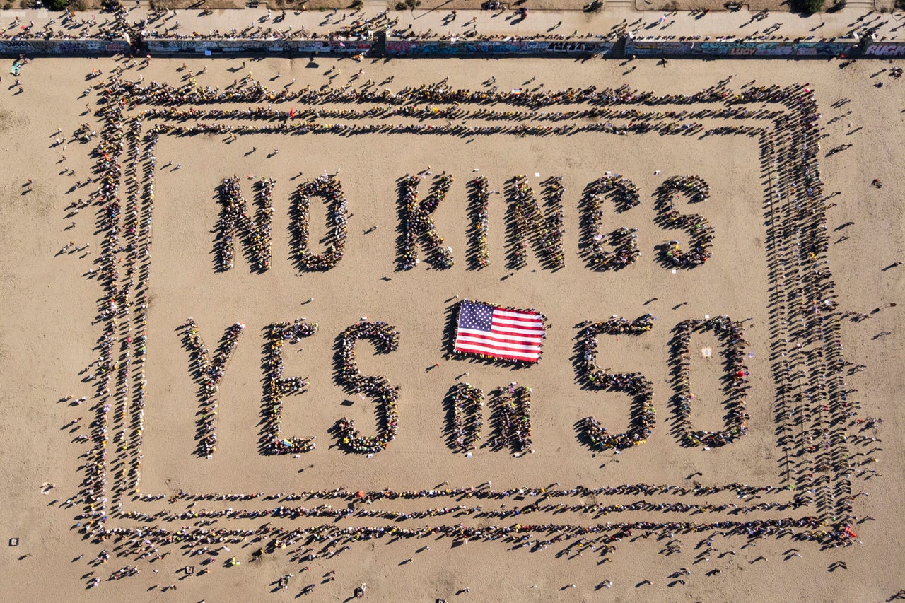 An aerial picture photo shows protesters forming a human banner on Ocean Beach in San Francisco on Oct. 18.