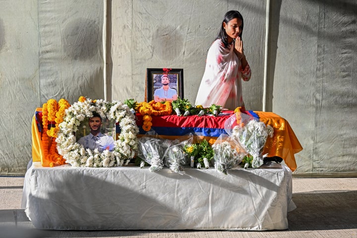 A woman mourns over the coffin of Bipin Joshi, a Nepali student who was killed while captive in Gaza, at the Tribhuvan International Airport in Kathmandu, on Oct. 20, 2025. Joshi's body was released by Hamas as part of the first phase of the U.S.-brokered ceasefire deal with Israel.