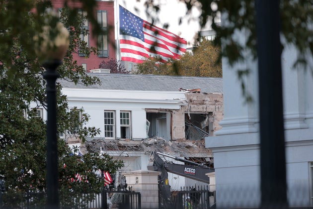 Workers demolish the facade of the East Wing of the White House.