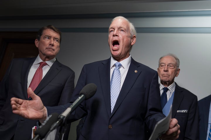 Sen. Ron Johnson (center), chair of the Permanent Subcommittee on Investigations, is flanked by Sen. Bill Hagerty (left) and Senate Judiciary Committee Chair Chuck Grassley, as he speaks with reporters on Oct. 6 to make an announcement about their oversight of the FBI.