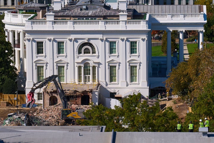 Construction workers, bottom right, above the U.S. Treasury, watch as work continues on a largely demolished portion of the East Wing of the White House, Thursday, Oct. 23, 2025, in Washington, ahead of construction of a new ballroom.