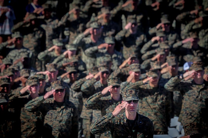 Members of the military salute during the Marine Corps 250th Anniversary event Oct. 18 at Camp Pendleton Beach in Oceanside, California.