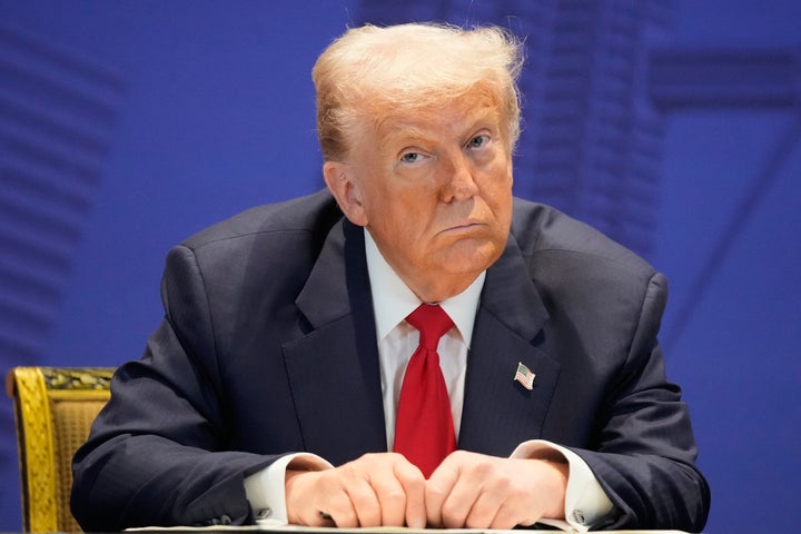 President Donald Trump reacts after signing a trade agreement with Malaysia's Prime Minister Anwar Ibrahim on the sidelines of the ASEAN Summit in Kuala Lumpur, Malaysia, Sunday, Oct. 26, 2025. (AP Photo/Mark Schiefelbein)