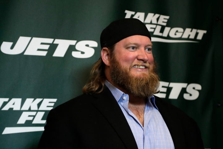 FILE - Former New York Jets center Nick Mangold poses for photographers on the green carpet ahead of an event unveiling the team's new NFL football uniforms, Thursday, April 4, 2019, in New York. (AP Photo/Julio Cortez, File)