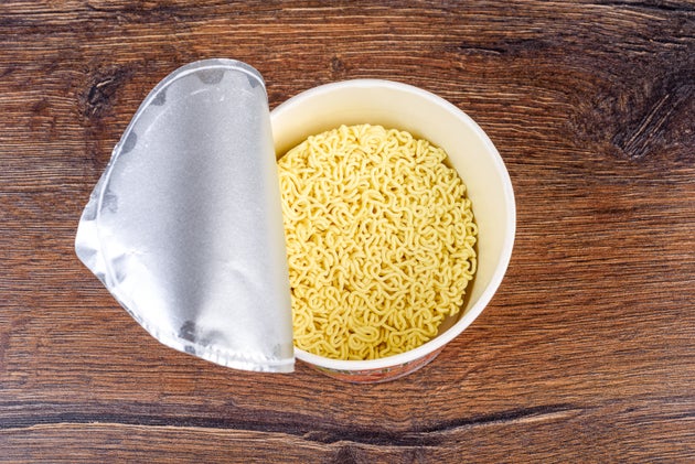 Open lid with dry instant noodles without spices. Copy space.