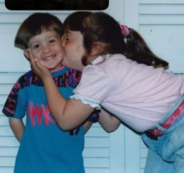 I am kissing my younger brother on the cheek; I am about 7 and he is 4. These are the wiggly fingers under the bathroom door that tormented my poor privacy-starved mother.