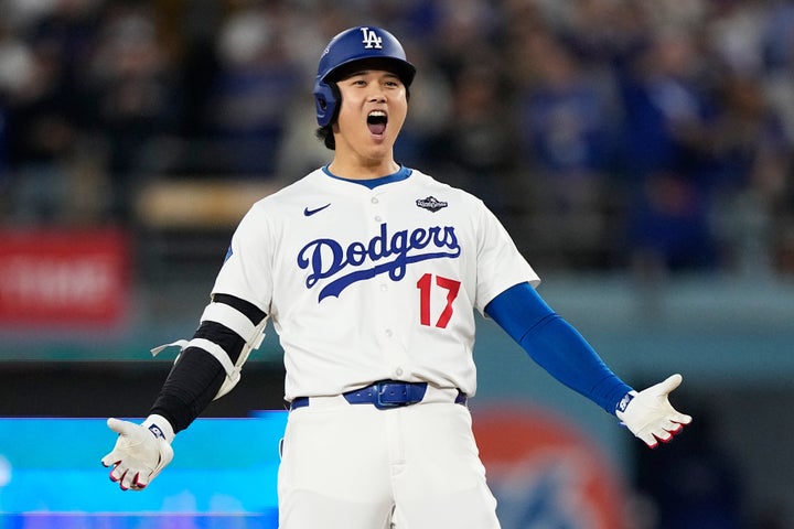 Los Angeles Dodgers' Shohei Ohtani celebrates during the fifth inning in Game 3 of baseball's World Series.