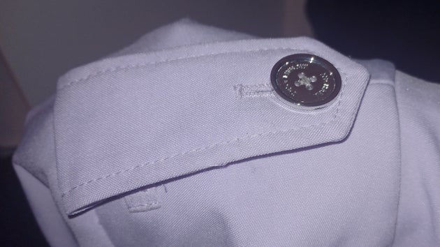 An epaulette on the writer's coat