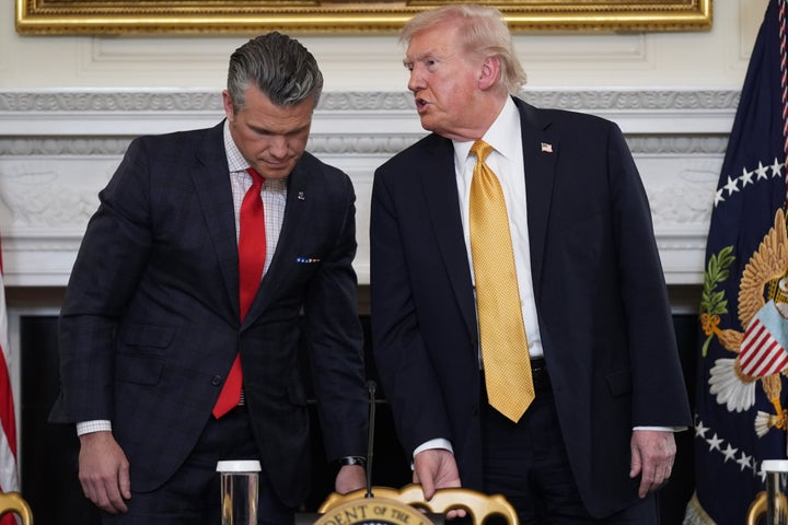 President Donald Trump talks with Defense Secretary Pete Hegseth after a roundtable on criminal cartels in the State Dining Room of the White House, on Oct. 23, 2025, in Washington.