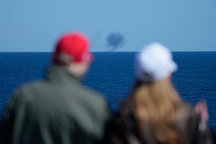 President Donald Trump and first lady Melania Trump watch a naval sea power demonstration, part of the Navy's 250th anniversary celebration, aboard the USS George H.W. Bush aircraft carrier in the Atlantic Ocean off the coast of Norfolk, Va., Sunday, Oct. 5, 2025. (AP Photo/Alex Brandon)