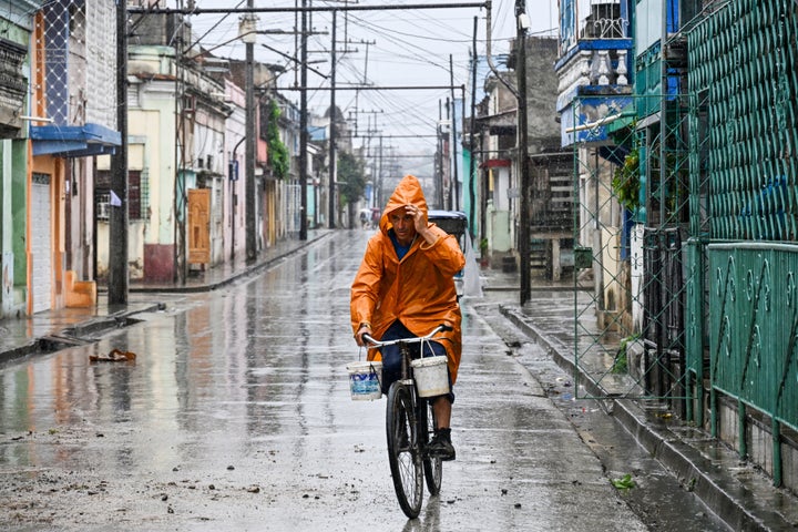 Resident rides a bike in the middle of the street before Hurricane Melissa hits the city of Santiago de Cuba, Cuba, on Oct. 28, 2025.