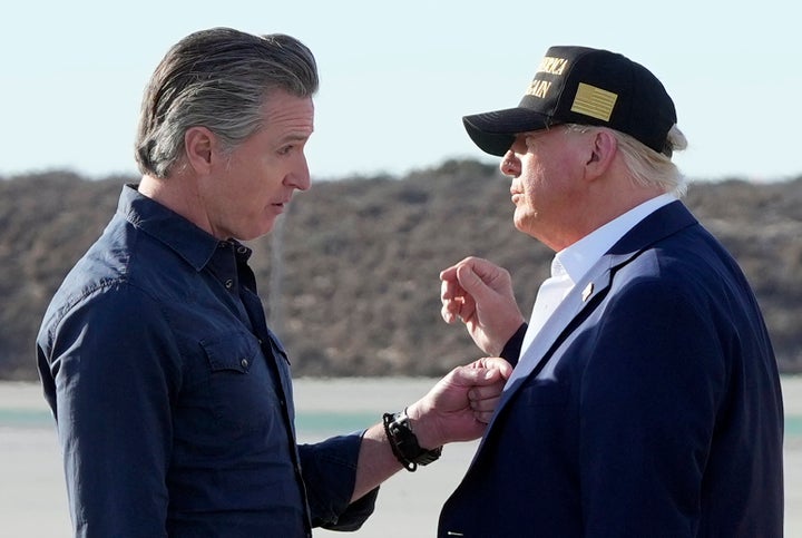 President Donald Trump (R) speaks with California Governor Gavin Newsom (L) after arriving on Air Force One at Los Angeles International Airport in Los Angeles, January 24, 2025.