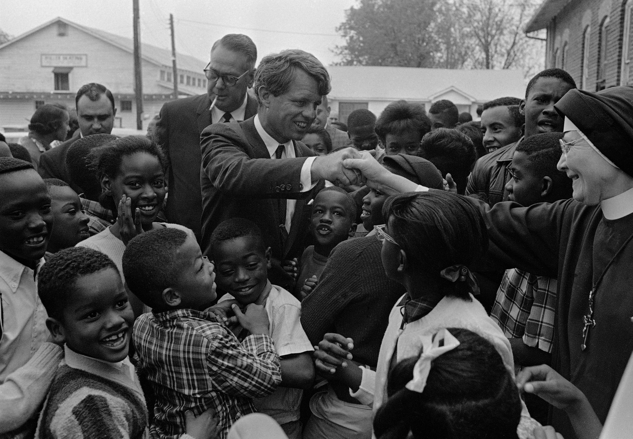 RFK thought food stamps could end hunger. RFK Jr. says they cause illness. 1 Senator Robert F. Kennedy (center) shakes the hand of a Catholic nun while surrounded by elementary students during his inspection of Mississippi's anti-poverty program, Greenville, April 11, 1967.