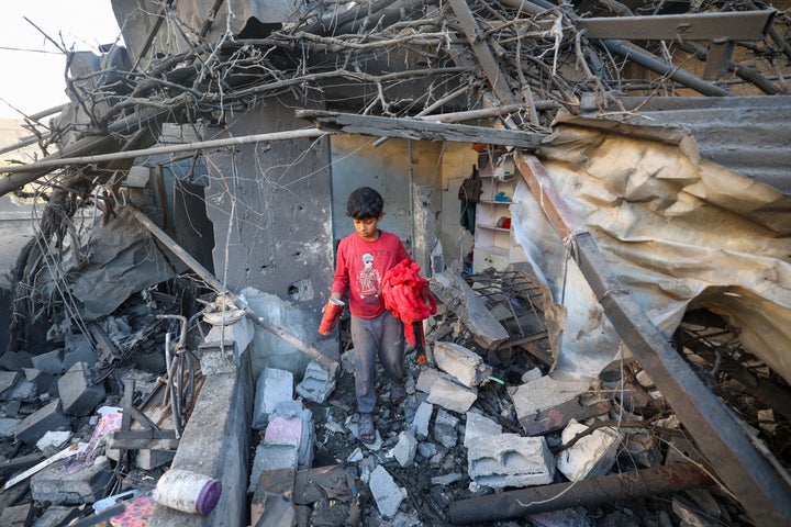 A Palestinian boy walks through the rubble of a house destroyed in an Israeli strike on central Gaza's Nuseirat camp, on Oct. 29, 2025.