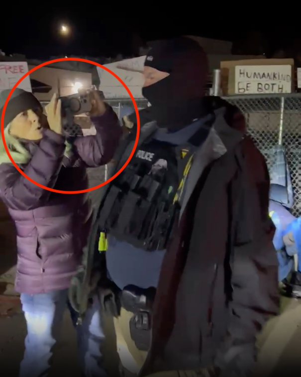 Franci Stagi, circled in red, moments before the ICE agent snatched the phone from her hands and violently assaulted her when she tried to retrieve it.