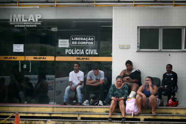Relatives wait outside the AfrAnio Peixoto Medico-Legal Institute (IMLAP) to retrieve the bodies of their loved ones killed during Operacao Contencao (Operation Containment) in the Penha Complex, in Rio de Janeiro, Brazil, on October 29, 2025. (Photo by MAURO PIMENTEL/AFP via Getty Images)