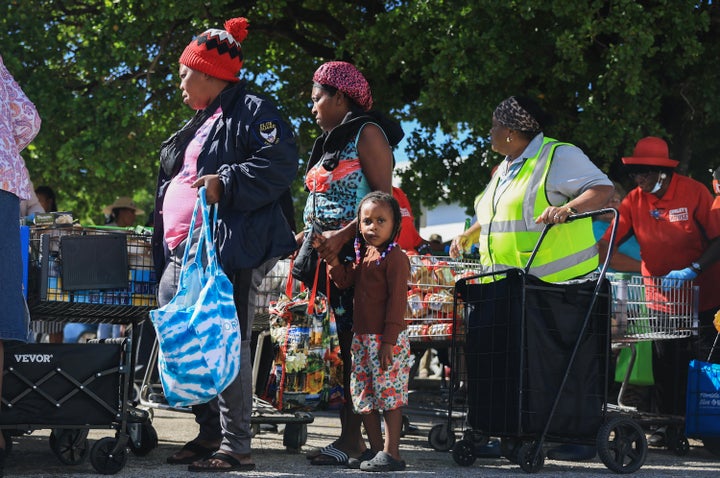 People receive groceries from the Curley's House Food Bank days before the Supplemental Nutrition Assistance Program (SNAP) benefits may expire due to the Federal government shutdown on Oct. 30 in Miami, Florida.