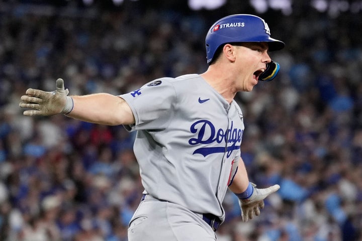Los Angeles Dodgers' Will Smith celebrates a home run against the Toronto Blue Jays during the11th inning in Game 7 of baseball's World Series, Sunday, Nov. 2, 2025, in Toronto. (AP Photo/Brynn Anderson)