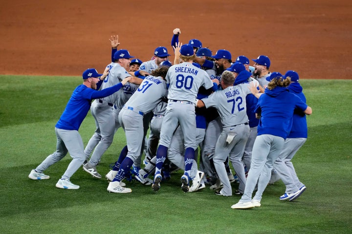 TORONTO, ONTARIO - NOVEMBER 02: Miguel Rojas #72 of the Los Angeles Dodgers and teammates celebrate after defeating the Toronto Blue Jays 5-4 in game seven of the 2025 World Series at Rogers Center on November 02, 2025 in Toronto, Ontario. (Photo by Mark Blinch/Getty Images)