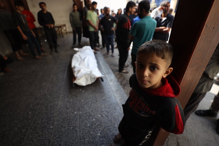 Palestinians at the Baptist Hospital mourn over the body of a man who was killed in an Israeli airstrike on a bazaar in eastern Gaza City's Shujaiya neighborhood, on Nov. 2, 2025.