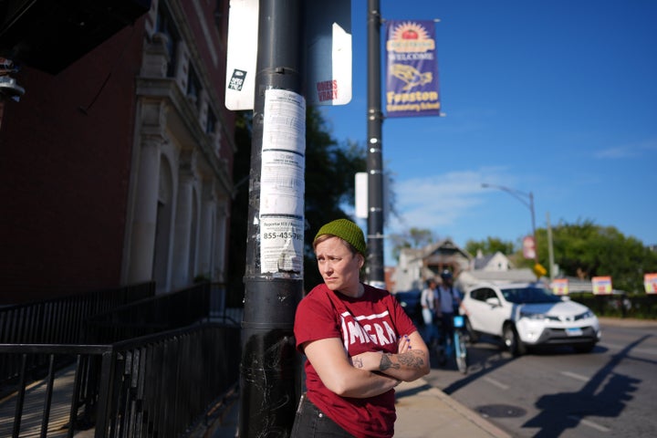 Neighborhood volunteer Amber Young wears a "Migra Watch" T-shirt as she looks out for federal immigration agents during school dismissal at Funston Elementary School, in Chicago's Logan Square neighborhood, on Oct. 16, 2025.