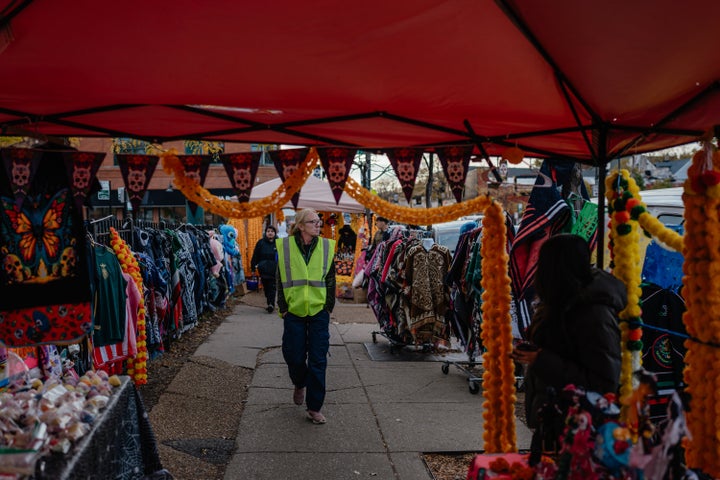 Volunteers in bright green vests walk the business corridor in Chicago's predominantly-Mexican Little Village neighborhood to monitor the streets during Halloween, on Oct. 31, 2025. The patrols were organized after Illinois Gov. JB Pritzker asked federal officials to pause immigration raids for the holiday weekend, which Homeland Security Secretary Kristi Noem rejected.