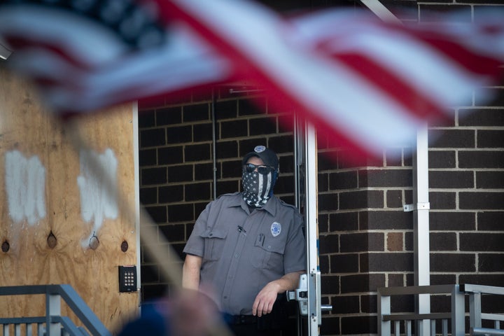 Security watches at demonstrators protest outside of an immigration detention center on Sept. 12, 2025, in Broadview, Illinois. The demonstrators were protesting the Trump administration's increase in immigration enforcement raids in the area which has been dubbed "Operation Midway Blitz."
