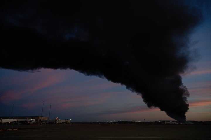 A plume of smoke wafts over airport property after reports of a plane crash at Louisville International Airport, Tuesday, Nov. 4, 2025, in Louisville, Ky.