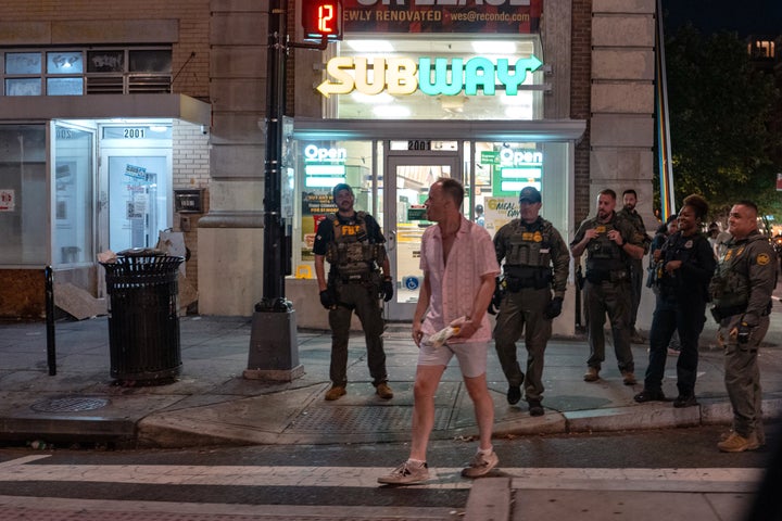 FBI and Border Patrol officers speak with Sean Charles Dunn, after he allegedly assaulted law enforcement with a sandwich, along the U Street corridor during a federal law enforcement deployment in the nation's capital on August 10, 2025, in Washington, DC President Donald Trump ordered an increased federal law enforcement presence in Washington, DC, in an effort to curb crime.