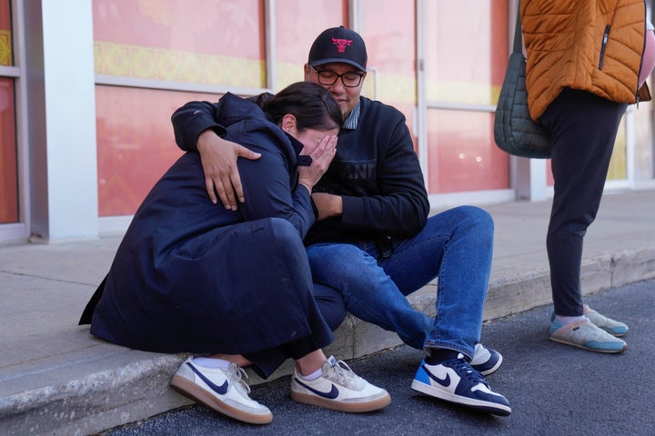 Parents Maria Guzman (L) and Sergio Rocha (R) comfort each other outside of Rayito de Sol Spanish Immersion Early Learning Center after federal immigration agents took an employee of the preschool in Chicago, on Nov. 5, 2025