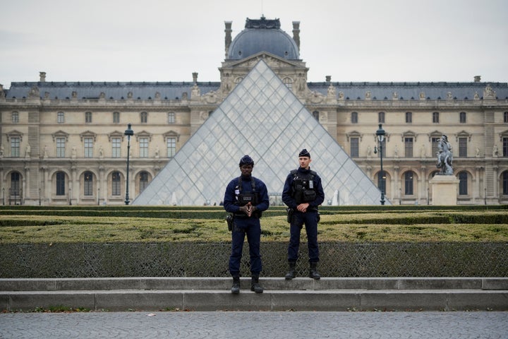 Police stand guard outside the Louvre museum on Oct. 19, after it was closed due to the robbery.