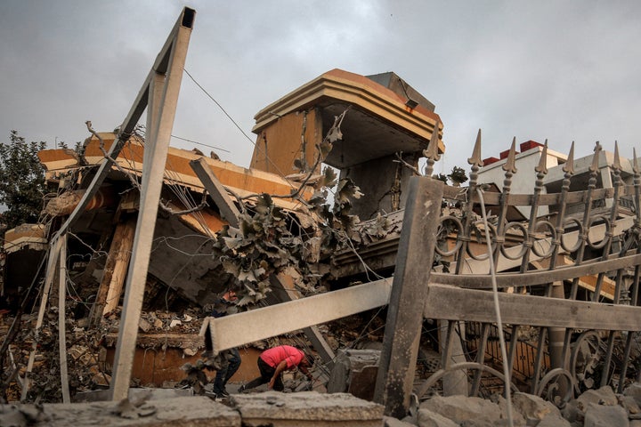 People inspect the rubble of a building that was destroyed in an Israeli airstrike on the southern Lebanese village of Teir Debba, on Nov. 6, 2025.